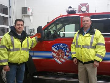 East Bethel fire fighters Dan Berry and Craig Chesler pose by their rescue vehicle. Fire fighters are trained to hurry to the scene of an accident in any weather.