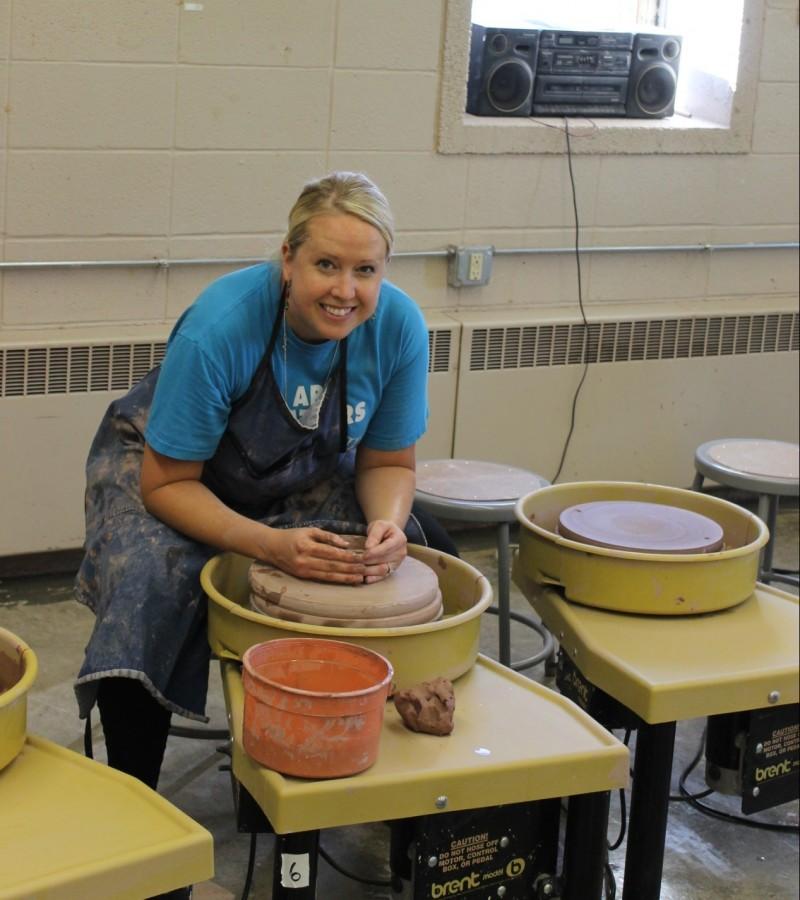 Ceramics+Teacher+Debra+Paquay+works+at+the+wheel+in+the+ceramics+studio.