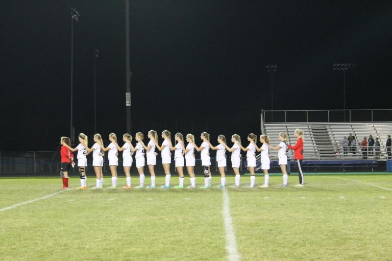 SFHS Girls Soccer team stands at attention for the National Anthem at the Semi-Finals. 