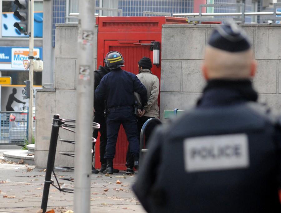 A man is arrested during a raid on an apartment in the Saint-Denis suburb of Paris, France on Wednesday Nov. 18, 2015. Several persons suspected of Friday's deadly attacks were surrounded and arrested or killed. (Alain Apaydin/Abaca Press/TNS)