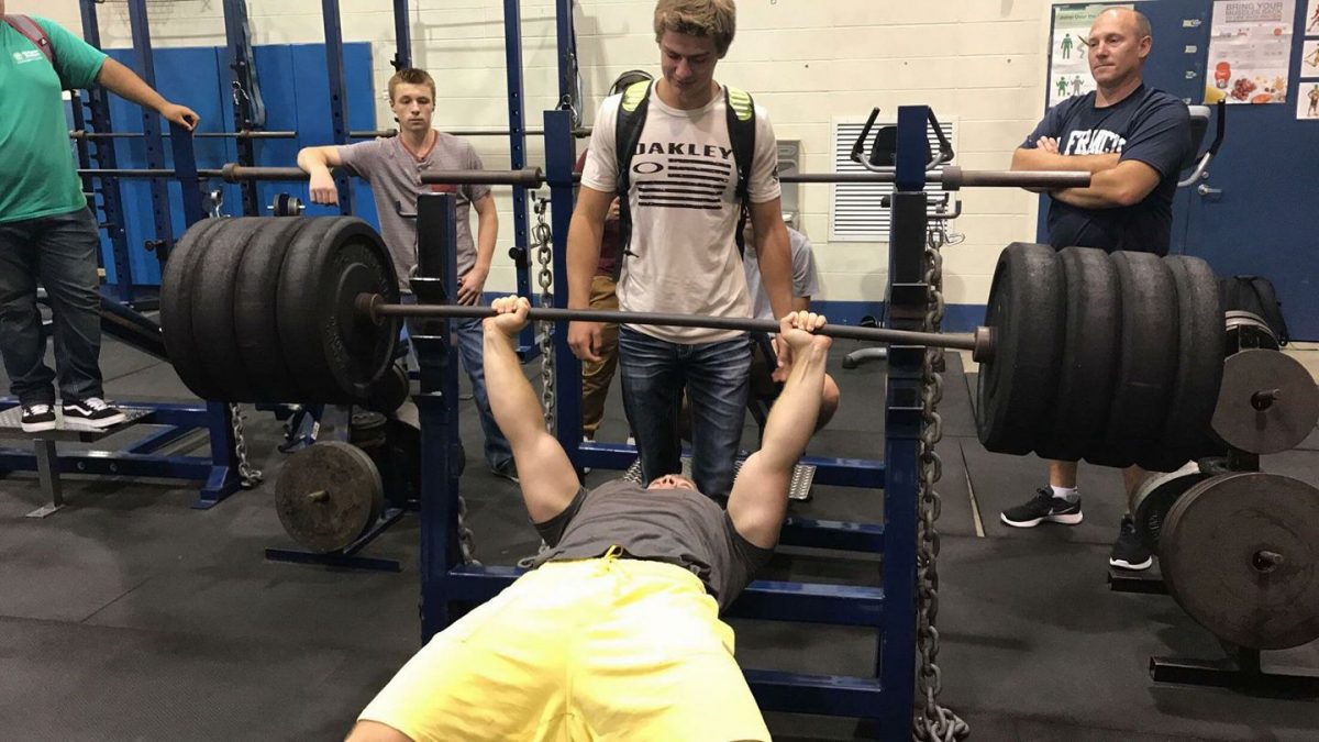 Senior Aaron Moskness  breaks the school bench record on September 12 during Saints Time, with a lift of 370 pounds.