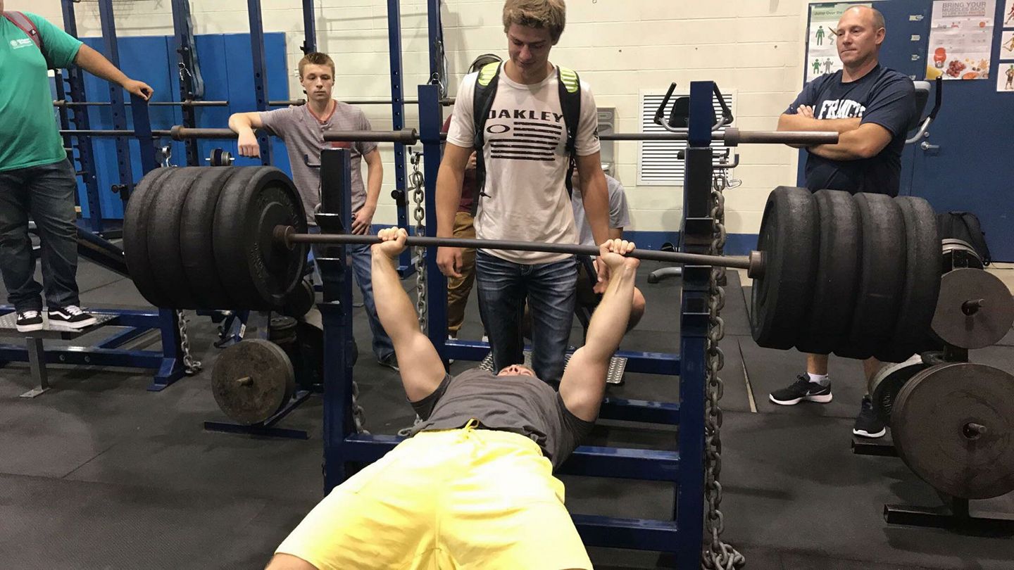 Senior Aaron Moskness breaks the school bench record on September 12 during Saints Time, with a lift of 370 pounds.