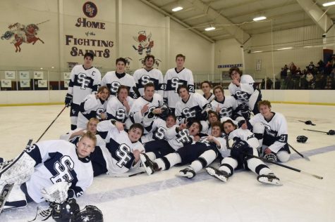 The Saints Boys Hockey team poses on the ice for a team picture.