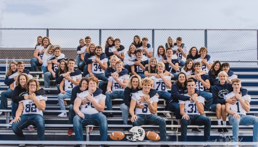 Senior+Varsity+Football+players+with+their+moms+in+the+stands.