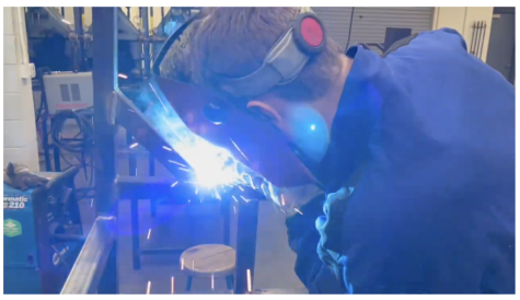 A student welds in Saints Manufacturing Class.
