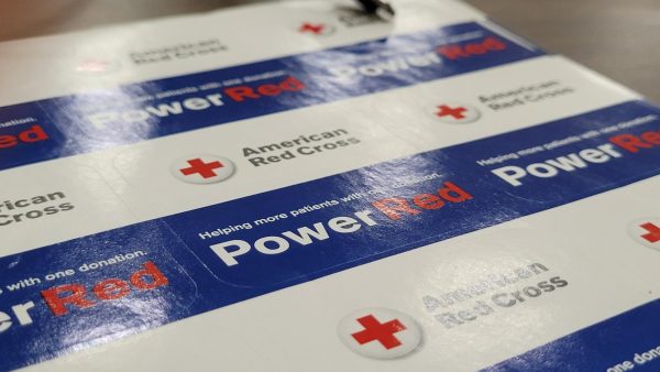 the NHS blood drive has a lot of donors shown by the PowerRed stickers given out.