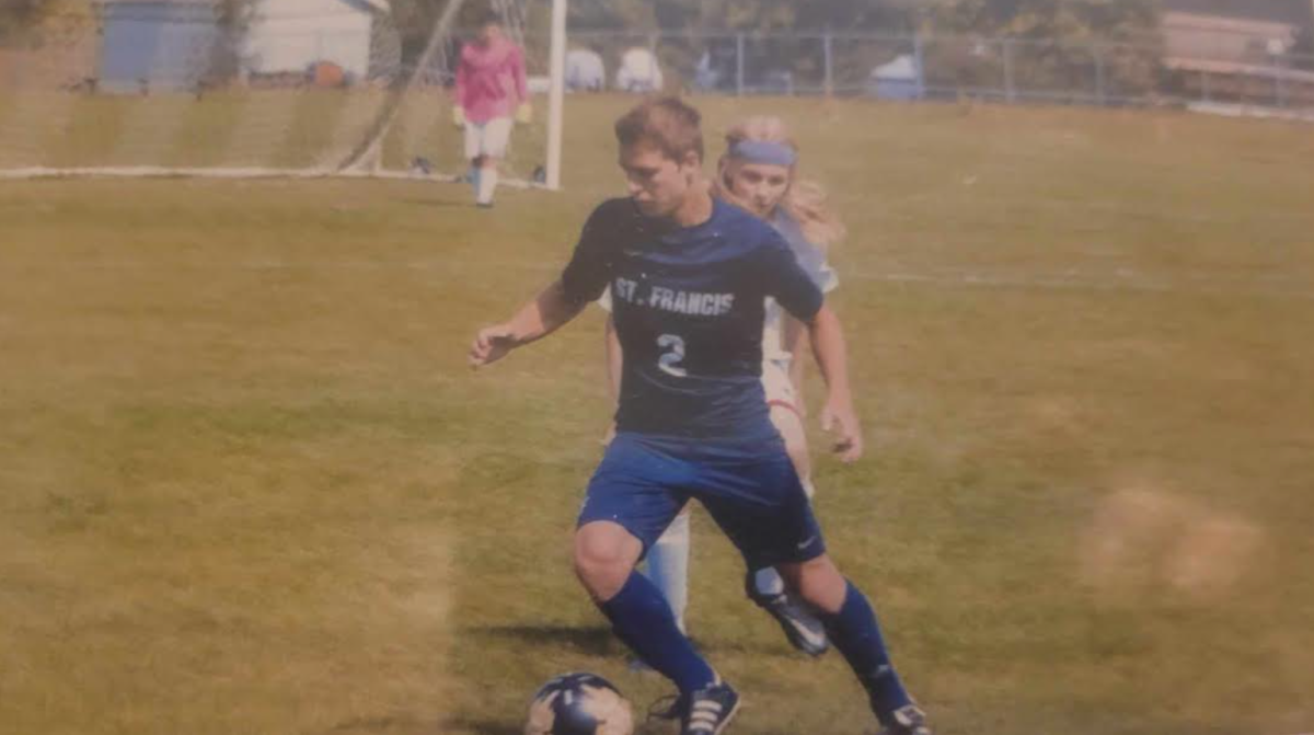 This is a picture of Logan Miller playing soccer for the Saint Francis High School team.